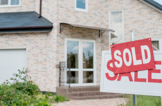 Sold sign in front of house