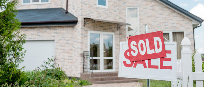 Sold sign in front of house