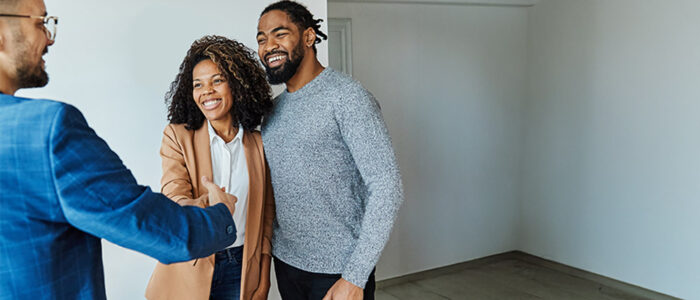 Couple and realtor in new home