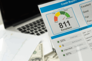 cropped view of man holding paper with credit report letters near laptop with blank screen