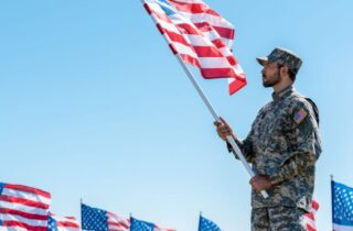 military man holding American flag