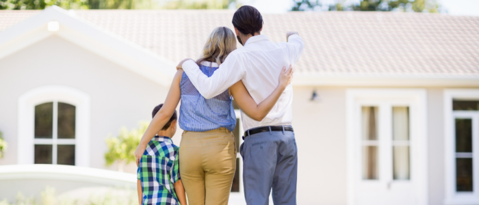 Parents And Son Standing In Garden