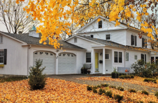 House Surrounded by Colorful Autumn Leaves on Lawn
